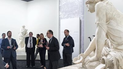 Jean-Luc Martinez president-director of Musee du Louvre and chief curator of the exhibition, 2nd left, leads the media preview. Christopher Pike / The National