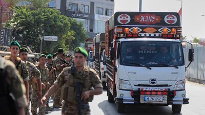 Lebanese soldiers escort lorries carrying weapons handed over by Palestinian factions from Rashidieh refugee camp as they pass through Tyre city on Thursday. AP Photo