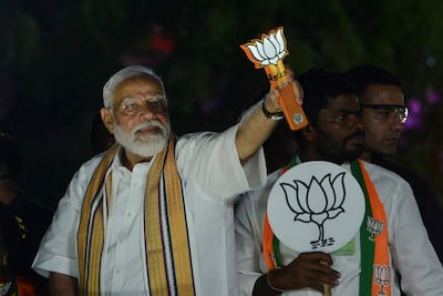 Indian Prime Minister Narendra Modi displays the Bharatiya Janata Party lotus symbol while on campaign in Chennai. AP