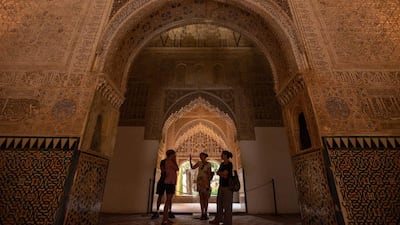 Tourists admire the Nasrid Palaces of the Alhambra, Granada