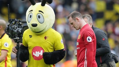 Manchester United’s Wayne Rooney walks from the pitch past the Watford team mascot ‘Harry the Hornet’ after losing on Sunday. Tim Ireland / AP Photo