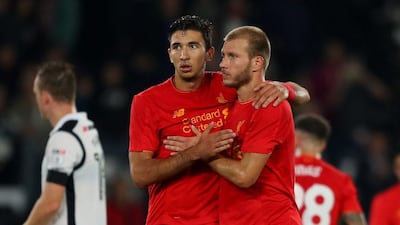 Ragnar Klavan of Liverpool and Marko Grujic of Liverpool celebrate victory in the League Cup third round match. Richard Heathcote / Getty Images