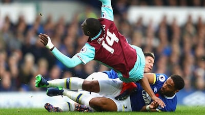 Pedro Obiang of West Ham, left, is tackled by Ashley Williams of Everton. Michael Steele / Getty Images