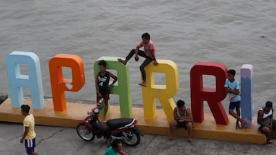 Filipino villagers relax near the shoreline of Aparri, Cagayan province ahead of Mangkhut. Francis R.Malasig / EPA