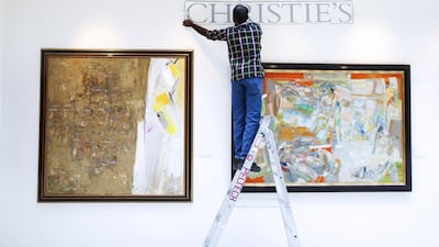 Workers finish setting up the modern and contemporary Arab, Iranian and Turkish Art Auction at Christie's at Jumeirah Emirates Towers in Dubai. The event takes place on Tuesday. Sarah Dea / The National