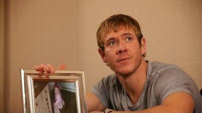 Dean Holden with a photograph of his daughter, Cici Milly, who died from illness on a family holiday in the Canary Islands.