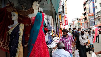 A Sri Lankan Muslim woman, right in black attire, walks in a busy street of Colombo, Sri Lanka. AP Photo