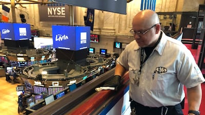 Porter Raul Rodriguez disinfects a railing at the New York Stock Exchange amid coronavirus fears. AP Photo