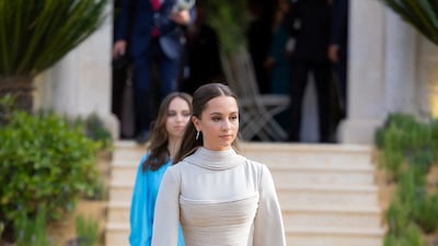 Jordan's Princess Iman wears a gown by Beirut label Ashi Studio, and her sister Princess Salma wears a blue Stella McCartney outfit