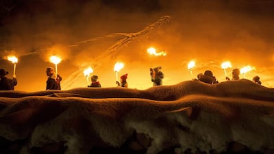 People walk with torches on the occasion of the ‘Funkensonntag’ in Appenzell, Switzerland. Gian Ehrenzeller / EPA