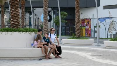 A family enjoys Yas Bay Waterfront, Abu Dhabi.