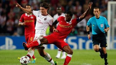 AC Milan, in white, will be happy after having scored an away goal in an away draw against PSV Eindhoven. Dean Mouhtaropoulos / Getty Images