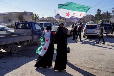 Women with Syrian flags in Raqqa. Reuters