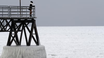 Michele King, 26, looks out over frozen Lake Erie, Wednesday, Jan. 3, 2018, in Cleveland. Dangerously cold temperatures have gripped wide swaths of the U.S. from Texas to New England. (AP Photo/Tony Dejak)