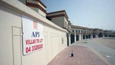 Adverts outside villas, like one in the Barsha area of Dubai, invite new tenants.