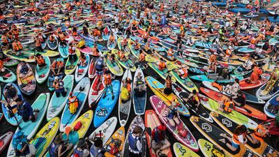 People attend a large-scale costumed Stand Up Paddleboarding (SUP) festival on the Moskva River in Moscow, Russia. EPA