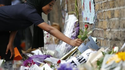 Children from Pakeman Primary School arrive to lay flowers in tribute to the victims of a June 19 van attack in at Finsbury Park mosque in north London