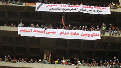 Banners reading "mercy and immortality to the martyrs of the October revolution; no nation, no work, until the downfall of the regime" from the vacant Turkish Restaurant Building overlooking Al Jumhuriya bridge. AFP