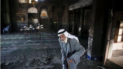 An elderly Israeli Arab man stands in a mosque in Tuba-Zanghariyya, in Upper Galilee, yesterday after the mosque was set on fire, allegedly by Jewish extremists. OLIVER WEIKEN / EPA