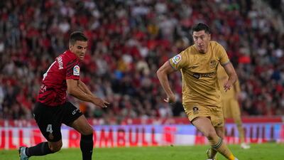 Robert Lewandowski runs with the ball while under pressure from Inigo Ruiz de Galarreta. Getty