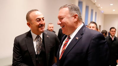 Turkish Foreign Minister Mevlut Cavusoglu shakes hands with US Secretary of State Mike Pompeo as they arrive for a bilateral meeting prior to a peace summit on Libya in Berlin. AFP