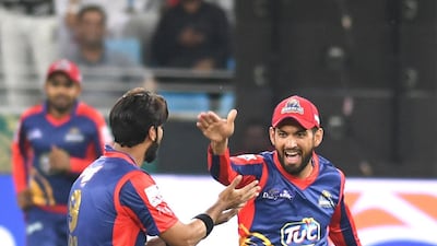 Karachi Kings players celebrate the dismissal of a Lahore Qalandars batsman.