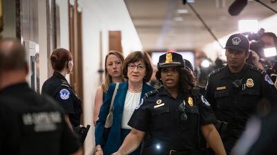 Senator Susan Collins, R-Maine, is escorted by US Capitol Police past waiting reporters trying to ask about Supreme Court nominee Brett Kavanaugh, on Capitol Hill. AP