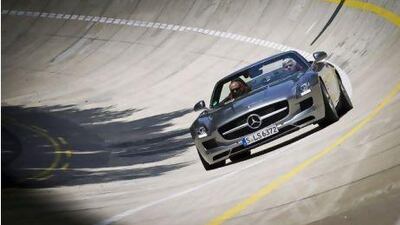 US chat show host Jay Leno finds out how much the SLS AMG Roadster hugs the road on Mercedes' banked track in Stuttgart. Courtesy of Patrick Gosling