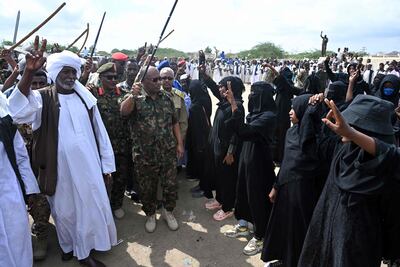 Members of Sudan's security forces walk past supporters in the opening ceremony of a military facility in the army-controlled city of Port Sudan. AFP
