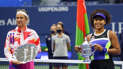 Naomi Osaka holds the championship trophy and Victoria Azarenka holds the finalist shield after their US Open final match. AFP