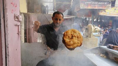 A man prepares bread for sale at a market in the old city of Sanaa, Yemen. EPA