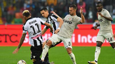 Miralem Pjanic, right, of Juventus competes for the ball with Kevin Lasagna of Udinese Calcio. Getty Images