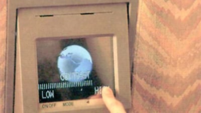 A passenger adjusts the video system. In 1996, Emirates took delivery of its first Boeing 777-200 and became the first airline to show live footage of take-off and landing on its in-flight entertainment system. Courtesy Emirates