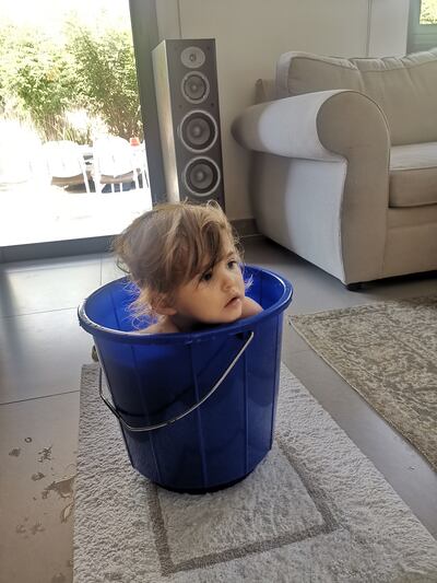 The writer's daughter loves sitting in a bucket and watching TV when she's unwell. Katy Gillett / The National