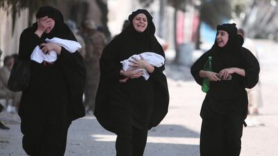 Women carry newborn babies after they were evacuated by the Syria Democratic Forces (SDF) fighters from an ISIL-controlled neighbourhood of Manbij, in Aleppo Governorate, Syria. The SDF has said ISIL was using civilians as human shields. Rodi Said / Reuters