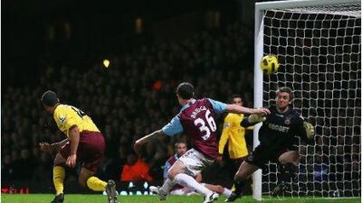 Theo Walcott, left, beats Wayne Bridge to the ball to score Arsenal's second goal.