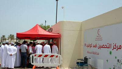 People arrive to get vaccinated against COVID-19 at the Sultan Qaboos Sports Complex in Oman's capital Muscat. AFP