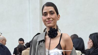 A silky slip dress worn under a trench coat, despite the cold weather