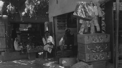 The interior of Abu Dhabi souq around 1960 with a shop selling bride chests or mandoos. Courtesy: BP Archive