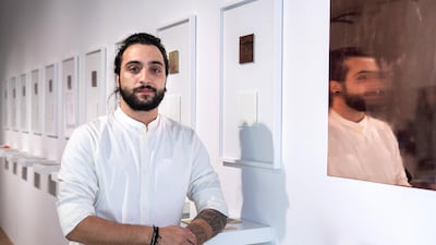 Syrian artist Majd Alloush with his work 'Liminal Margin' at the UAE Unlimited exhibition Intimaa: Belonging. Victor Besa / The National