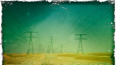 Day trip with friends to the Western Region and the Mazayin Dhafra Camel Festival, 220 kms west of Abu Dhabi on December 20, 2013. We accidentally followed this road under high tension wires. Picture taken with the Hipstamatic app for the iPhone. Liz Claus / The National