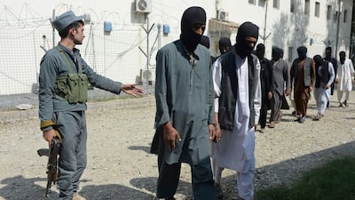 This photo, taken on October 3, 2017, shows a member of the Afghan security forces escorting alleged ISIS and Taliban fighters in Jalalabad. Noorullah Shirzada / AFP