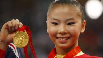 He Kexin of China holds her gold medal on the poduim during the medal presentation ceremony for the women's uneven bars final in the artistic gymnastics competition at the Beijing 2008 Olympic Games August 18, 2008.