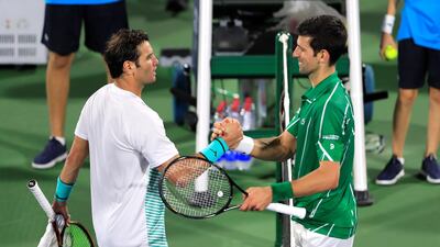 Novak Djokovic shakes hands with Malek Jaziri after their match. Reuters