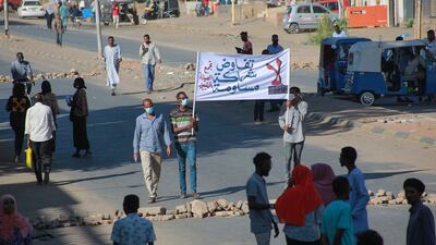Sudanese demonstrators lift a banner which reads in Arabic "No negotiation, no partnership, no compromise" during a rally in Khartoum. AFP