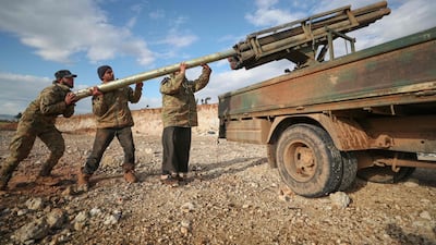 Syrian rebel fighters load a Grad rocket launcher in northwestern Syria. AFP