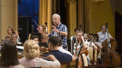 Sir Richard Armstrong leads the Western Australia Symphony Orchestra in rehearsal for Abu Dhabi Classics’ season opener at Emirates Palace on Thursday night. Antonie Robertson / The National