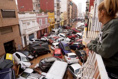 Flashing floods have left vehicles scattered across streets in Valencia. AP