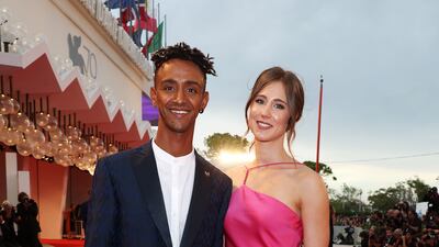 Italian athlete Yeman Crippa, in a suit and white T-shirt, and Sofia Filippi, in a pink satin gown. Getty Images