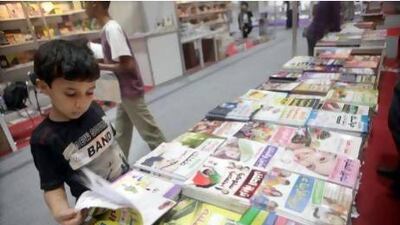 Suhail Omar, 12, looks through some of the Arabic titles on offer at the book fair yesterday. Sammy Dallal / The National